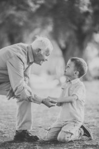Grandfather, grandson, holding hands, eye contact, sideways, Grandfather, grandson, holding hands, eye contact, sideways,